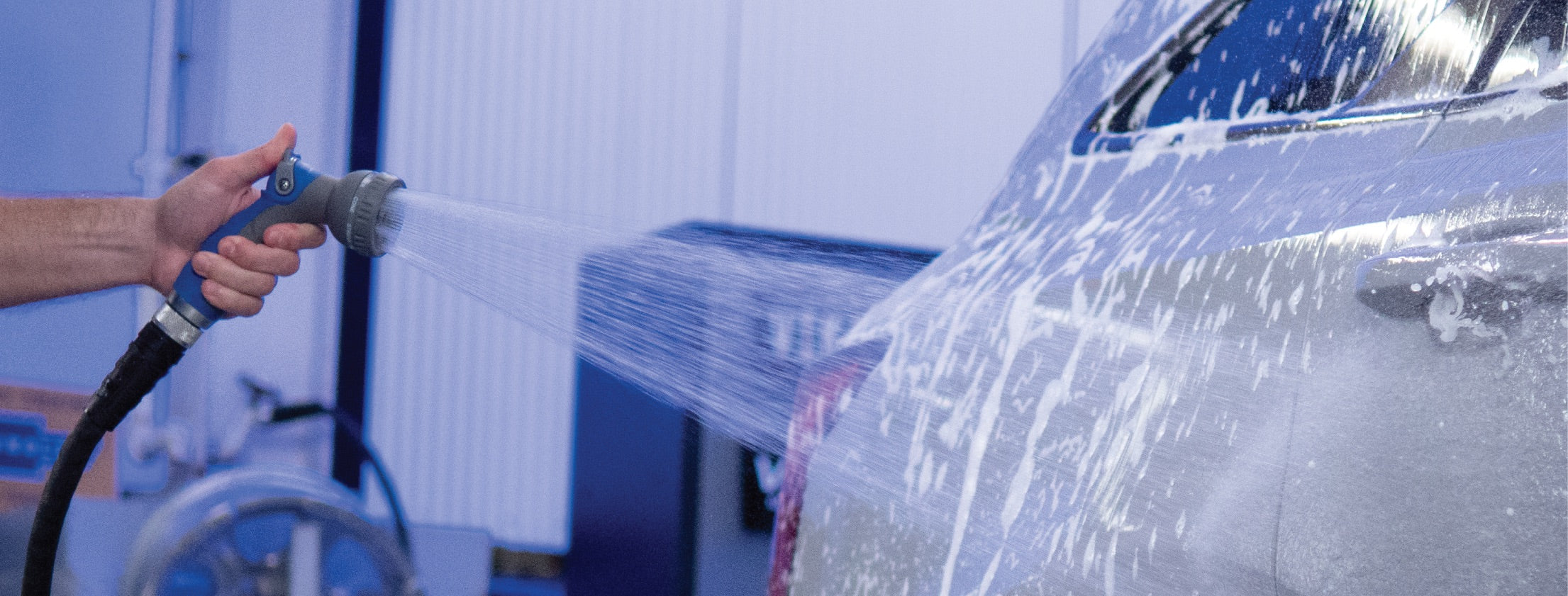 spraying a car in a garage