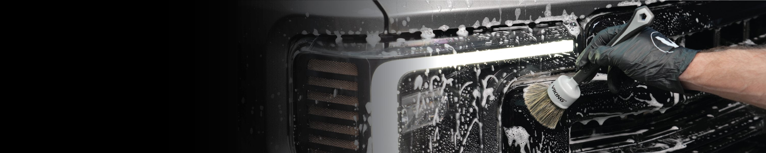 man spraying a car in garage