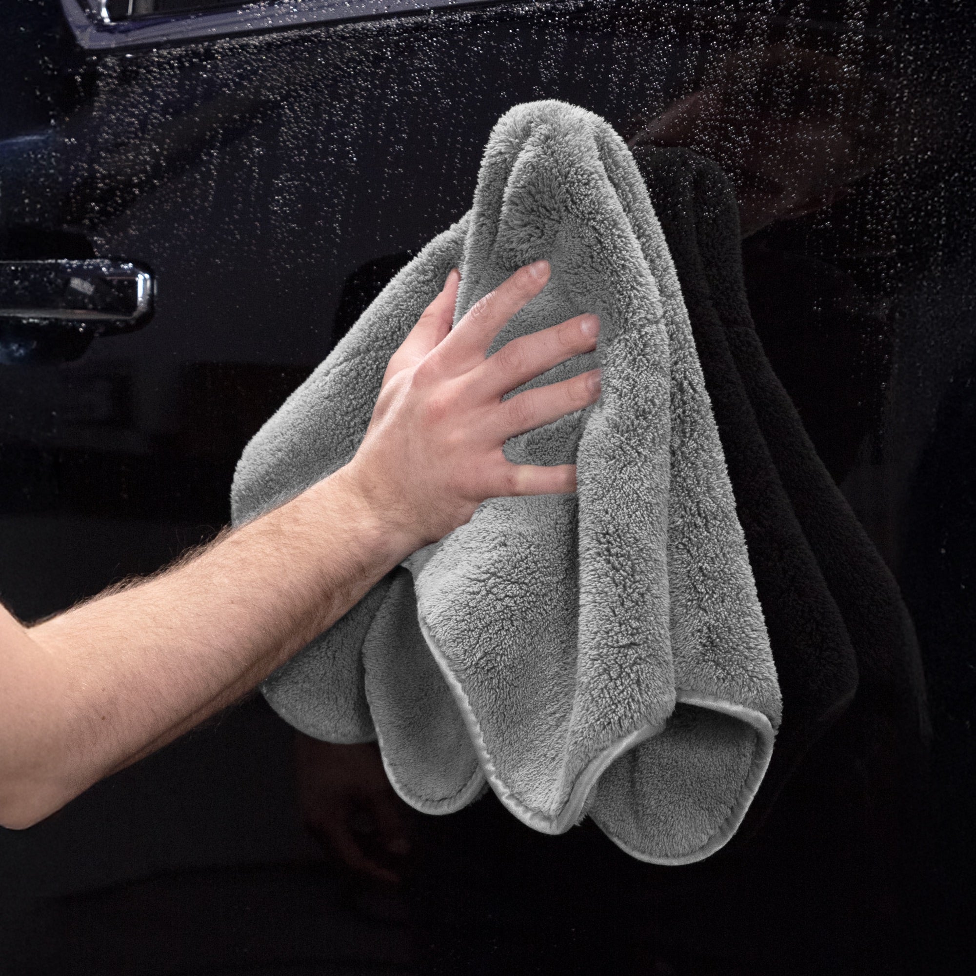 monster drying towel drying exterior of car door