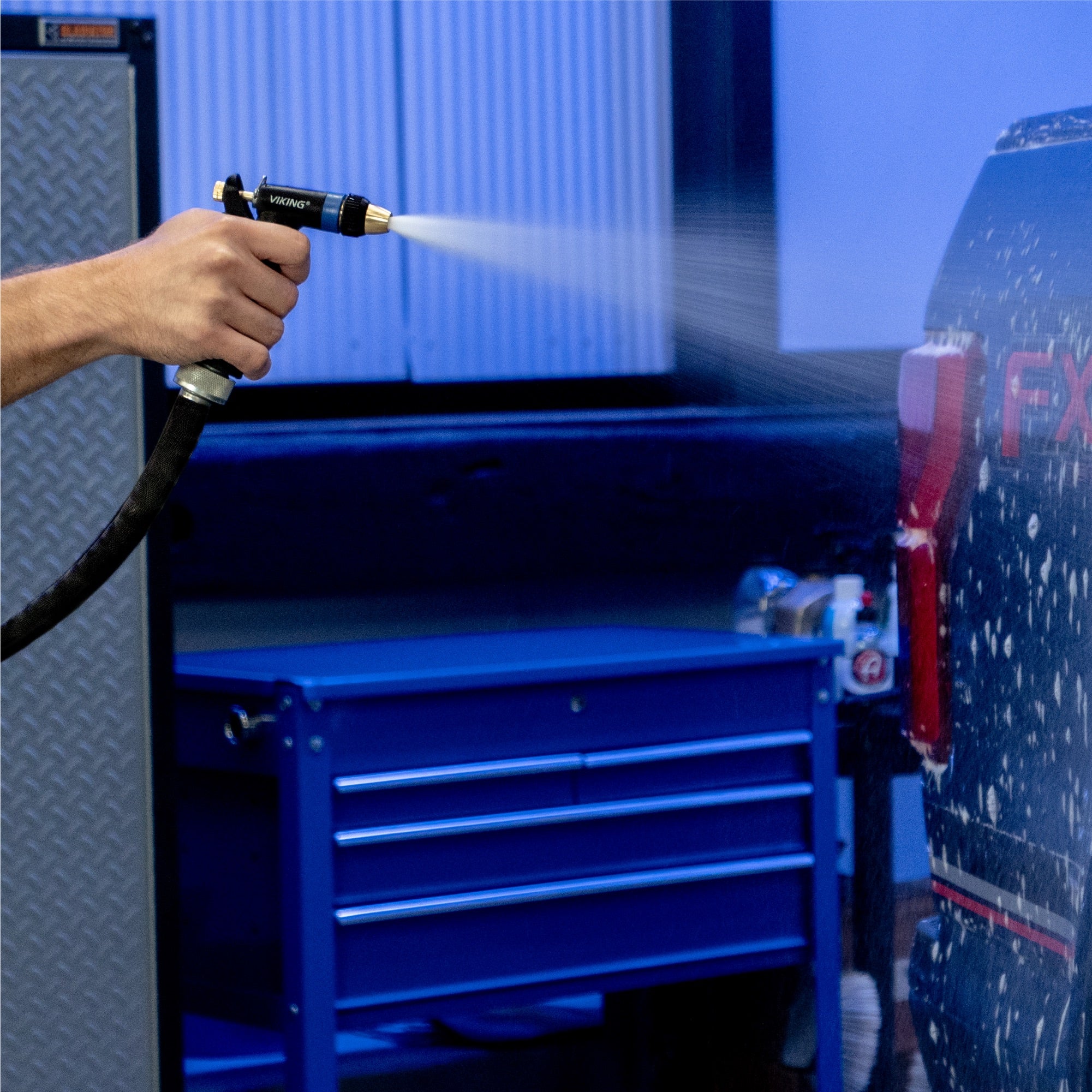 heavy duty spray nozzle spraying car in garage